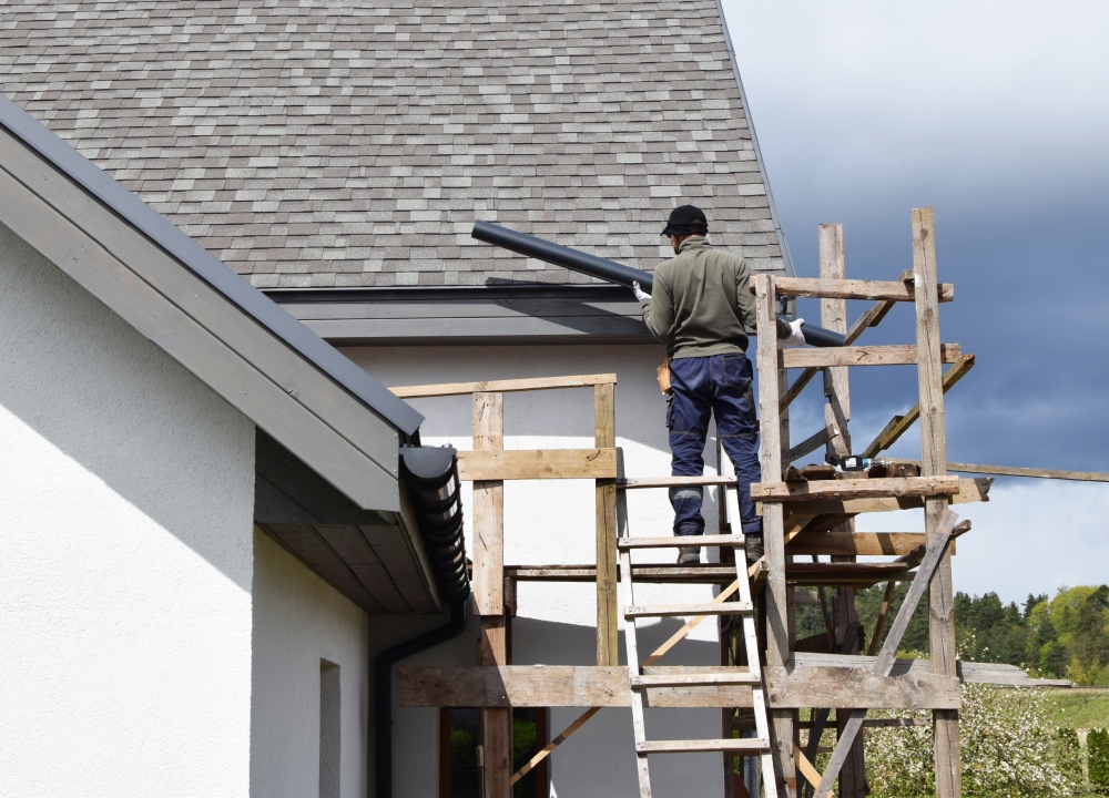 Construction worker carrying out roofing work