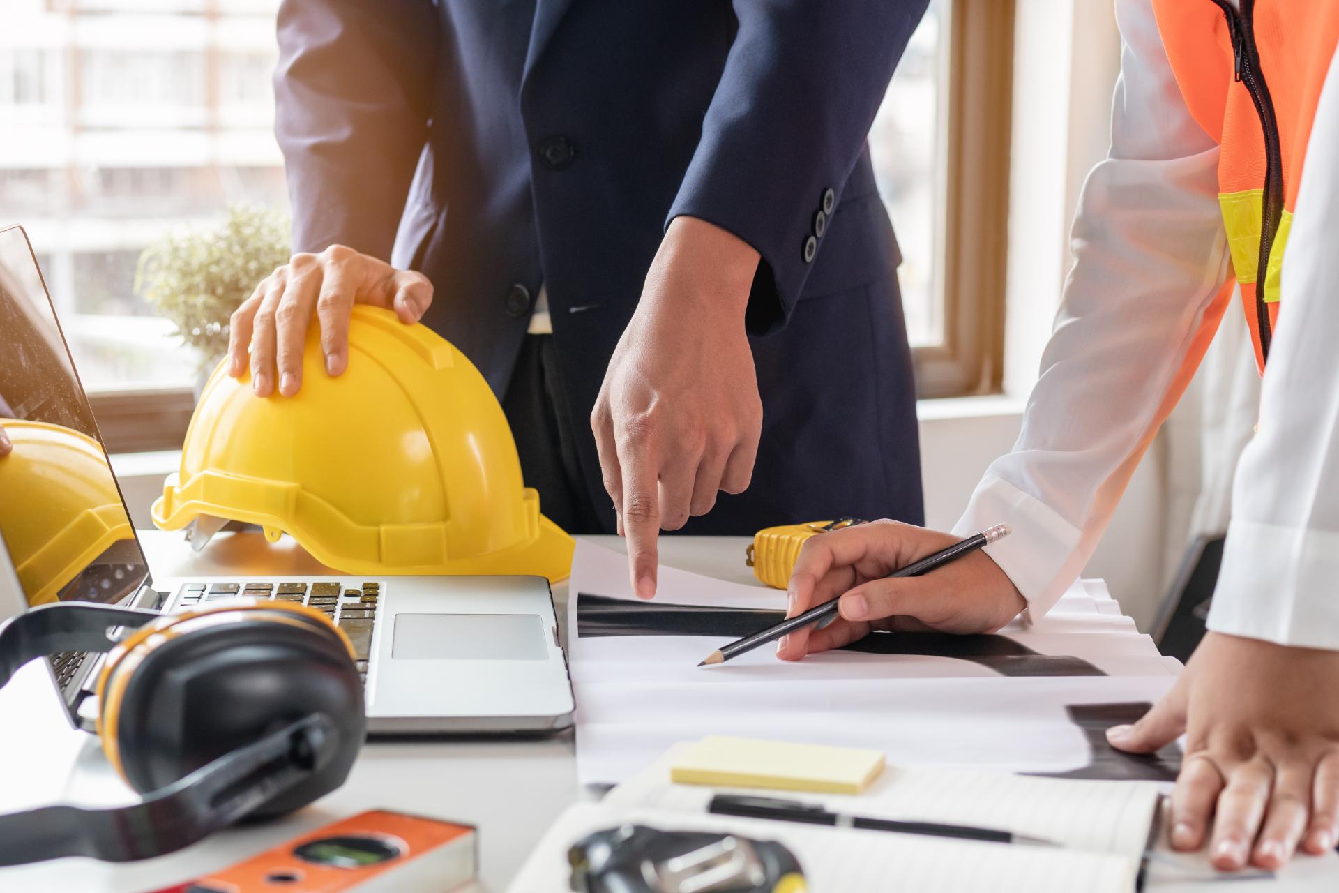 Construction workers discussing project with clients